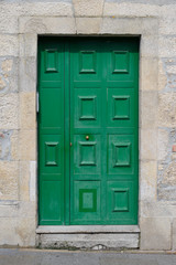 Fototapeta na wymiar old green door in a stone wall