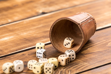 cup dice on wooden background with cube