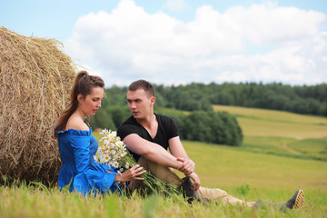 couple in love in a field at sunset