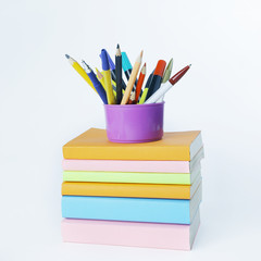 Fototapeta premium stand with pencils on a stack of books .photo with copy space
