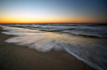 Sunset and ocean. Beach and sea at sunrise.