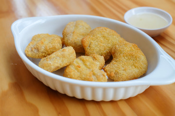 Chicken nuggets on wooden table 