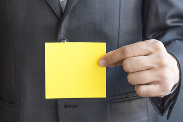 Hand with yellow blank Paper card for text. Copy space