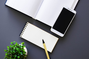 office workspace top view with diary and smartphone