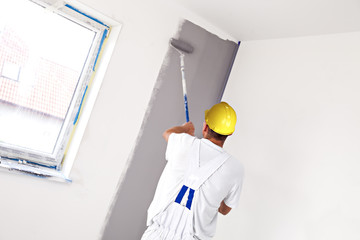 House painter. Indoor painter painting room wall