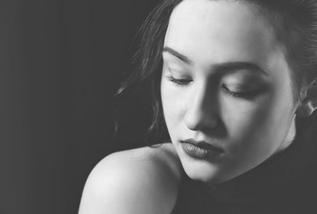 Black and white portrait of a model girl with closed eyes