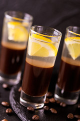 Alcoholic cocktail silver bullet with gin, coffee liqueur and lemon.