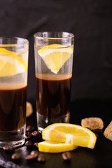 Alcoholic cocktail silver bullet with gin, coffee liqueur and lemon.