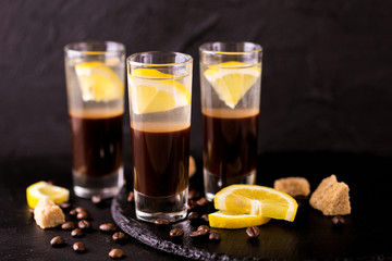 Alcoholic cocktail silver bullet with gin, coffee liqueur and lemon.