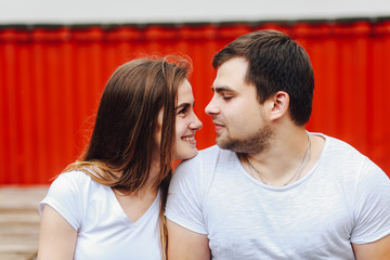 guy looks into the eyes of a girl on a red background