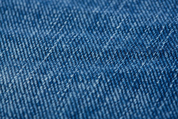 Denim jeans texture background with torn. The texture of the colored cotton fabric. Stitched texture jeans background. Fashion jeans button. Pocket and rivet on jeans. Fiber and fabric structure.