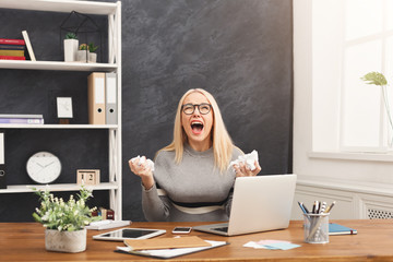 Furious business woman shouting at work place