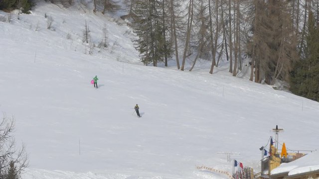 Skiers playing with a ball on a ski slope