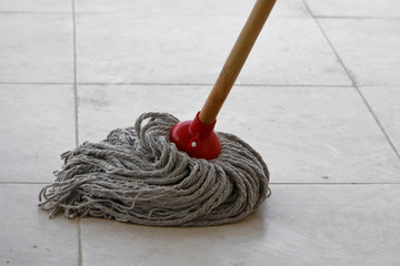 Wet mop on dirty tile