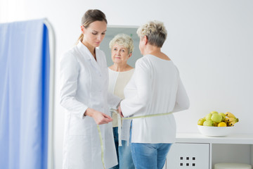 Dietician taking measurements of patient