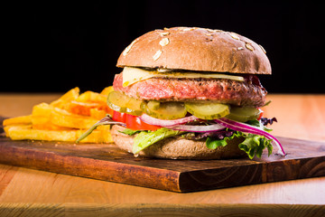 Delicious hamburger served on wooden planks