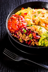 nachos with melted cheese, guacamole and red beans
