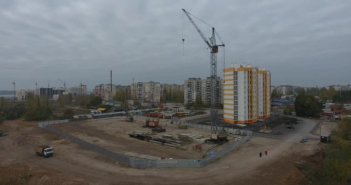 Construction crane on construction site on outskirts of cityscape, Central Europe