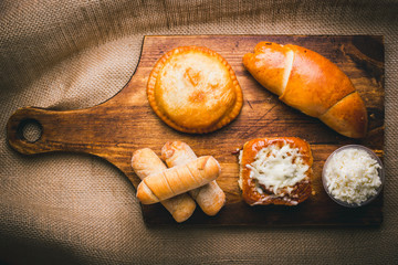 different types of Venezuelan meals, golfeados, tequeños, cachito, empanada, etc.