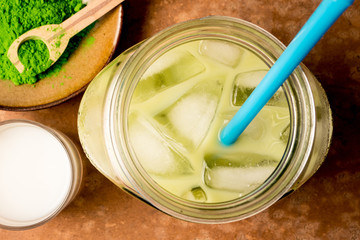 Top view of Iced green tea Iced green tea with milk on brown grunge background