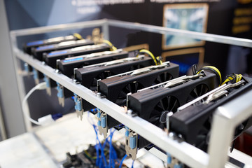 Crypto currency ethereum mining equipment rig - lots of gpu cards on mainboard. Graphics processing units connected to motherboard with cables. Server with decryption and encryption computing machines