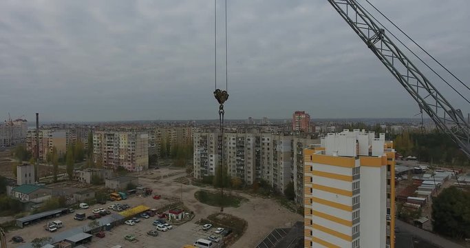 Construction crane on construction site on outskirts of cityscape, Central Europe