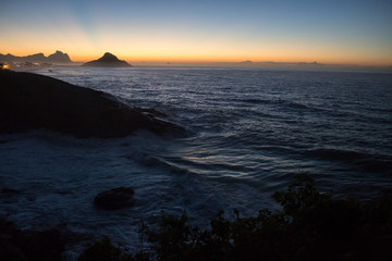 Obraz premium color photography of sunrise between mountain on macumba beach in rio de janeiro city