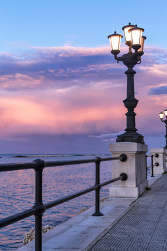 Bari seafront at sunset. Ancient original street lamp, amazing sky color. seascape.