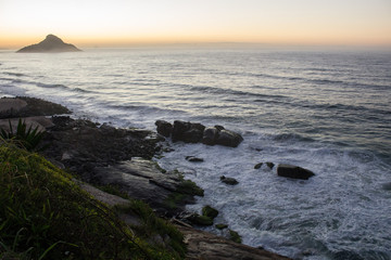 color photography of sunrise between mountain on macumba beach in rio de janeiro city