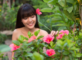 Obraz na płótnie Canvas Beautiful and charming young Thai girl in flower garden, Ayutthaya, Thailand