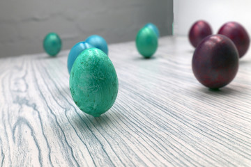 Yellow and pink flowery Easter eggs on pink background with hyacinth and tulips. Shallow dof .