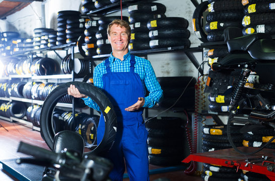 Man standing with auto tires