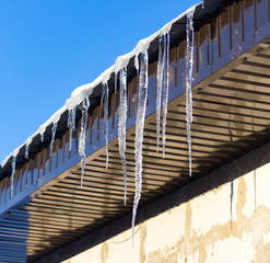 Icicle from the roof of the house in winter