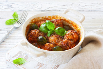 Meatballs and brussel sprouts stewed in tomato sauce