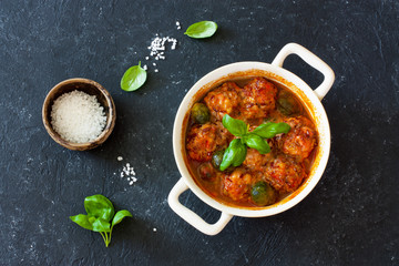 Meatballs and brussel sprouts stewed in tomato sauce