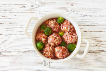 Raw meatballs and brussel sprouts