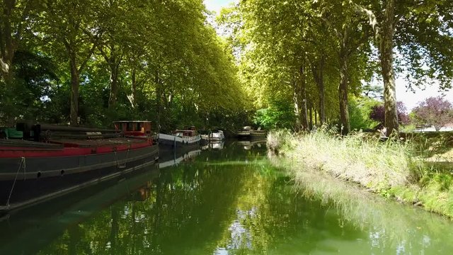 Barge on a river. Péniches sur le canal du midi. Toulouse France