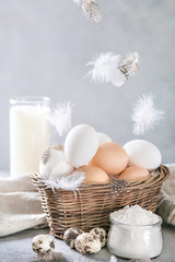 Ingredients for baking - flour, eggs, milk. Floating feather - 199955594