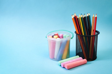 Fototapeta premium colored pencils and chalks on a wooden table. School supplies.