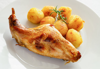 fried potato and roasted rabbit decorated with rosemary