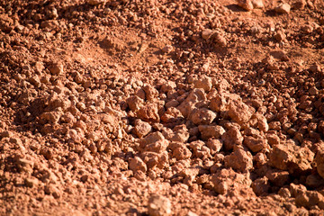 Red clay soil on nature as a background