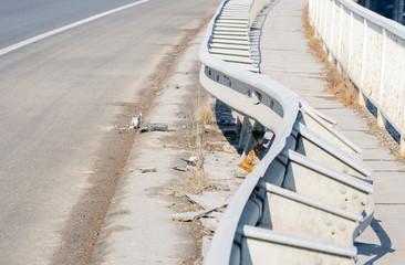 Obraz premium Damaged metal safety fence on the bridge from car crash accident from unsafe driving