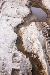 Snow melts on the road as a background