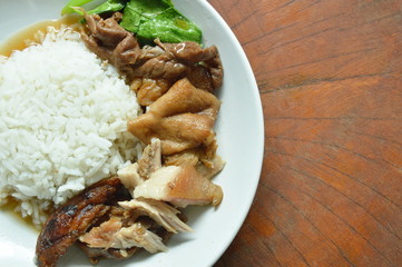 boiled pork leg in black Chinese herb soup slice with rice on plate