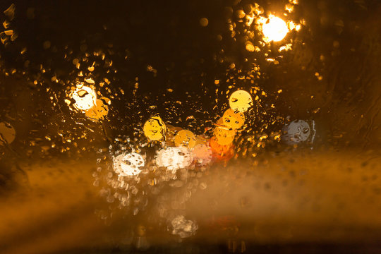 Snow with droplets on the car glass at night