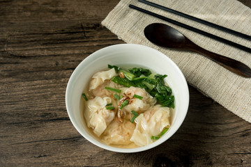 Shrimp wonton with braised pork in soup on wooden table - Asian food style  / Select focus image