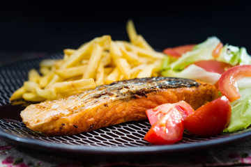 Grilled Salmon with fresh lettuce and Golden French fries