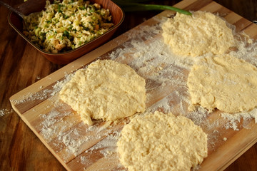 Process of forming buns with filling on a wooden board sprinkled with flour