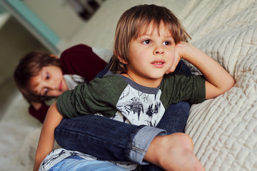 Two happy brothers  having fun together at home. Boys