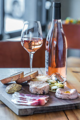 Charcuterie board with toasted bread and wine
